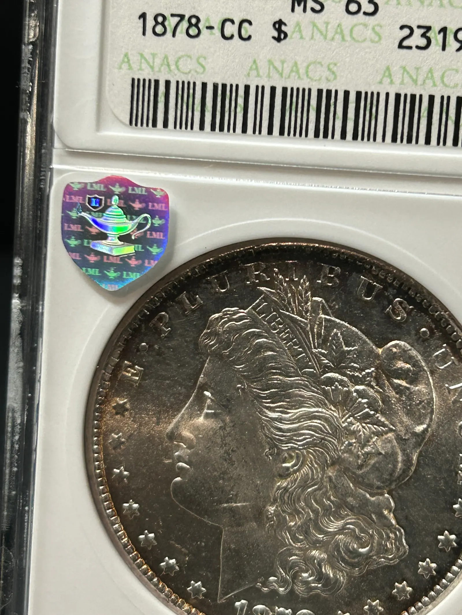 Silver Shield alongside credit card for scale